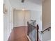 Upstairs hallway with hardwood floors, decorative railing, and neutral paint at 3904 Tristan Way, Suwanee, GA 30024