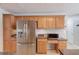 This modern kitchen features stainless steel appliances, including a refrigerator, microwave, and granite countertops at 3904 Tristan Way, Suwanee, GA 30024