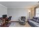 Comfortable living room with hardwood floors, ample seating, and a well-lit workspace, perfect for modern living at 3904 Tristan Way, Suwanee, GA 30024