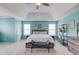 Spacious bedroom featuring a tray ceiling, soft carpet, and bright aqua walls at 3904 Tristan Way, Suwanee, GA 30024