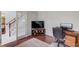 Cozy office space with hardwood floors, a work desk, and a glass door leading to the staircase at 3904 Tristan Way, Suwanee, GA 30024