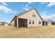 Landscaped backyard features a large yard, screened patio, and beige siding at 558 Carleton Pl, Locust Grove, GA 30248