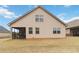 View of backyard and rear home exterior with a screened porch at 558 Carleton Pl, Locust Grove, GA 30248