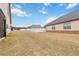 View of home's expansive backyard with a white fence in the background at 558 Carleton Pl, Locust Grove, GA 30248