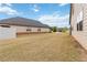 Large backyard features partial fence line, and houses to the right and left at 558 Carleton Pl, Locust Grove, GA 30248