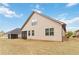Expansive backyard featuring a home's beige siding and a screened in patio at 558 Carleton Pl, Locust Grove, GA 30248