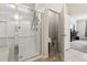 A renovated bathroom with a glass shower, an open toilet area, and a view into the bedroom at 558 Carleton Pl, Locust Grove, GA 30248