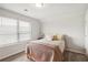 Cozy room with a twin bed, a warm blanket, natural light, and pale paint at 558 Carleton Pl, Locust Grove, GA 30248