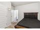 Bedroom featuring neutral walls, dark bedding, soft carpet, and ample closet space at 558 Carleton Pl, Locust Grove, GA 30248