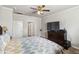 A bedroom featuring a bed, TV on dresser, and an open door with white trim and walls at 558 Carleton Pl, Locust Grove, GA 30248