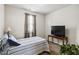 Small room with a bed, window, TV, and a potted plant accenting the room at 558 Carleton Pl, Locust Grove, GA 30248