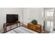 Small guest bedroom with a TV, drawers, and a peek into an adjourning room at 558 Carleton Pl, Locust Grove, GA 30248