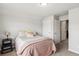 Cozy bedroom features a bed with a patterned comforter and a small black nightstand at 558 Carleton Pl, Locust Grove, GA 30248
