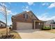 Charming brick home with a two-car garage and well-manicured lawn, enhanced by a bright blue sky at 558 Carleton Pl, Locust Grove, GA 30248