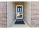 Close-up of the home's front door, showcasing brickwork and an inviting entrance with a screen door at 558 Carleton Pl, Locust Grove, GA 30248