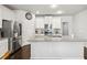 Well-lit kitchen featuring white cabinets, stainless steel appliances, and a granite countertop island at 558 Carleton Pl, Locust Grove, GA 30248