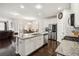Spacious kitchen with an island, stainless steel appliances, and a view into the dining room at 558 Carleton Pl, Locust Grove, GA 30248
