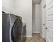 Practical laundry room equipped with a modern washing machine and ample shelving at 558 Carleton Pl, Locust Grove, GA 30248