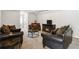 Comfortable sitting area with a fireplace, a media center, a dark accent furniture and an open floor plan at 558 Carleton Pl, Locust Grove, GA 30248