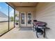 Relax on this screened porch with double doors and a gas grill at 558 Carleton Pl, Locust Grove, GA 30248