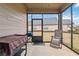 Enjoy outdoor living on this screened porch with comfortable seating and backyard views at 558 Carleton Pl, Locust Grove, GA 30248