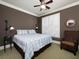 Bedroom featuring a ceiling fan, white shutters, modern light fixtures, and a comfortable armchair at 62 Emerson Hill Sq, Marietta, GA 30060