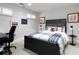Neutral-toned bedroom with shutters, multiple wall-mounted art pieces, a desk and a carpeted floor at 62 Emerson Hill Sq, Marietta, GA 30060