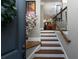 Inviting entryway with hardwood stairs and railing leads to the open concept living area at 62 Emerson Hill Sq, Marietta, GA 30060