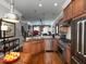 Gourmet kitchen with stainless steel appliances, granite countertops, hardwood floors, and breakfast bar at 62 Emerson Hill Sq, Marietta, GA 30060