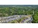 An aerial photograph captures a neighborhood surrounded by a lush, dense forest and greenery at 163 Neese Farm Dr, Woodstock, GA 30188