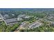 Aerial view of a community surrounded by trees, with commercial buildings in the background at 163 Neese Farm Dr, Woodstock, GA 30188