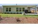 A fenced backyard with a grassy lawn and covered outdoor patio at 163 Neese Farm Dr, Woodstock, GA 30188