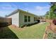 Backyard view of home and outdoor patio with manicured lawn and flower bed at 163 Neese Farm Dr, Woodstock, GA 30188