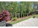Well manicured backyard features wooden fence and fresh plants at 163 Neese Farm Dr, Woodstock, GA 30188