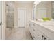 This bathroom features double sinks, a glass shower, modern fixtures and finishes at 163 Neese Farm Dr, Woodstock, GA 30188