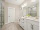 Bathroom with double vanity, sleek white cabinetry, and a frameless glass shower at 163 Neese Farm Dr, Woodstock, GA 30188