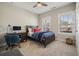 This neutral-toned bedroom features a ceiling fan, desk, and two windows with blinds at 163 Neese Farm Dr, Woodstock, GA 30188