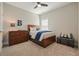 This carpeted bedroom features a wooden bed, ceiling fan, and matching dark wood dresser at 163 Neese Farm Dr, Woodstock, GA 30188