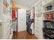 This walk-in closet has built-in shelving, drawers, and ample hanging space for organization at 163 Neese Farm Dr, Woodstock, GA 30188