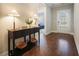 Inviting foyer with hardwood floors and a stylish console table, offering a glimpse into the home's elegant interior at 163 Neese Farm Dr, Woodstock, GA 30188