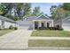 Well-maintained single-story house with a gray facade, a green lawn, and an attached garage, perfect for suburban living at 163 Neese Farm Dr, Woodstock, GA 30188