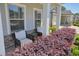 Cozy front porch with chairs and red landscaping at 163 Neese Farm Dr, Woodstock, GA 30188