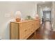 A hallway with hardwood floors and a light wood dresser at 163 Neese Farm Dr, Woodstock, GA 30188