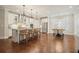 Spacious kitchen with a large center island, seating, stainless appliances and a view to the dining area at 163 Neese Farm Dr, Woodstock, GA 30188