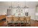 Kitchen island features stainless steel dishwasher and sink, pendant lighting, and seating at 163 Neese Farm Dr, Woodstock, GA 30188