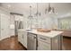 Kitchen island features stainless steel dishwasher and sink, quartz countertop, and a view of dining area at 163 Neese Farm Dr, Woodstock, GA 30188