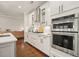 Bright kitchen features stainless steel appliances, subway tile backsplash, and glass-front cabinets at 163 Neese Farm Dr, Woodstock, GA 30188