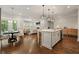 Open concept kitchen with island, seating, and a view of the cozy living room at 163 Neese Farm Dr, Woodstock, GA 30188