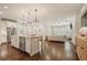 Bright, open kitchen with stainless steel appliances and hardwood floors flowing into the living room at 163 Neese Farm Dr, Woodstock, GA 30188
