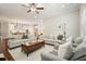 Open-concept living area with hardwood floors and neutral-colored furniture, and barstool seating at island at 163 Neese Farm Dr, Woodstock, GA 30188